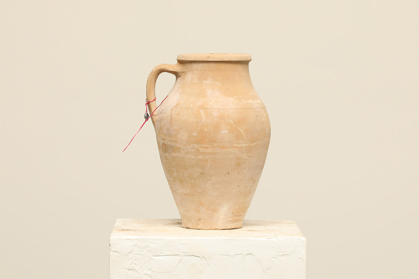 A one-of-a-kind natural Turkish vintage vase pot with a handle, crafted from terra cotta clay, this piece showcases timeless quality and antique craftsmanship, adding a unique touch of history to your space