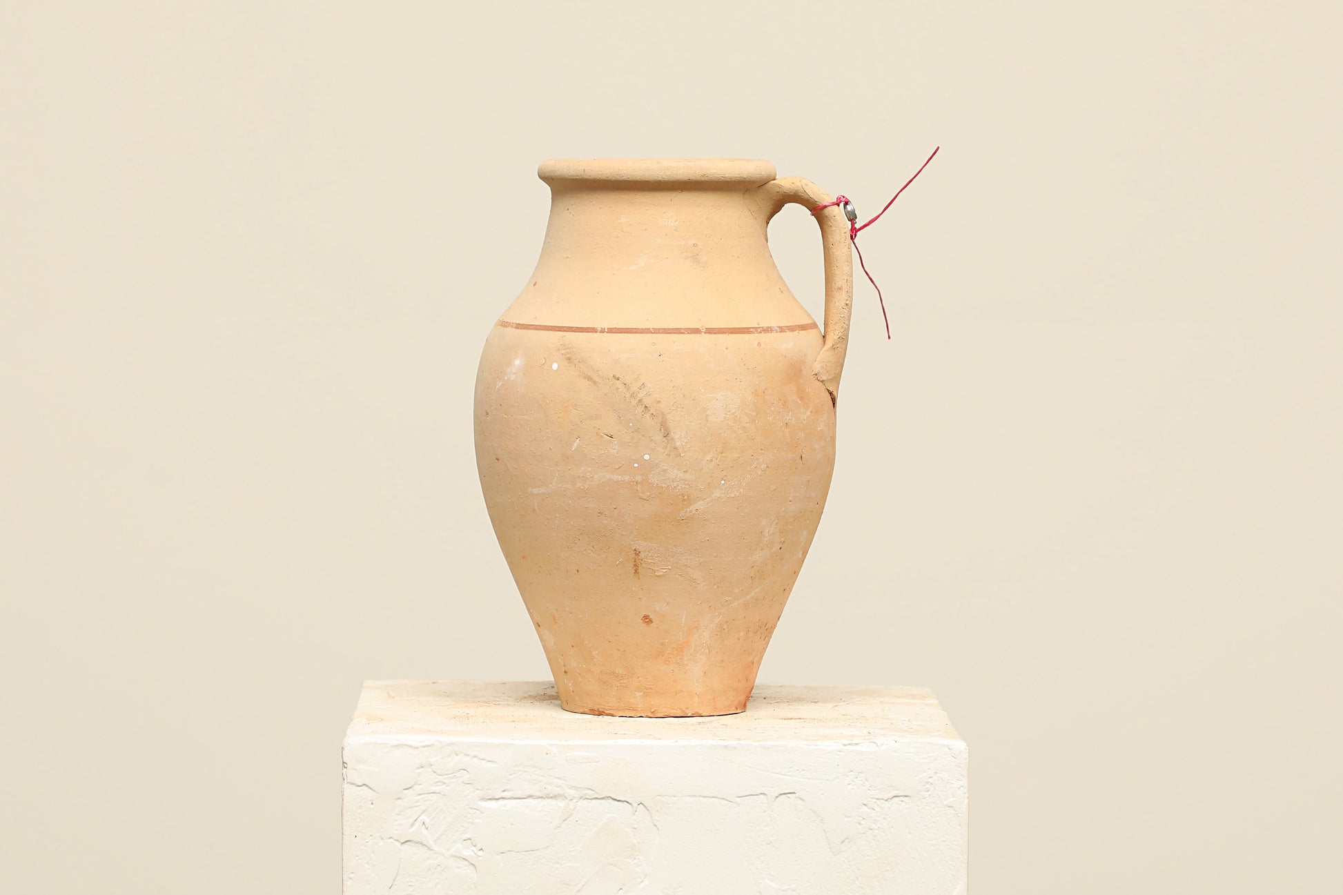A one-of-a-kind natural Turkish vintage vase pot with a handle, crafted from terra cotta clay, this piece showcases timeless quality and antique craftsmanship, adding a unique touch of history to your space