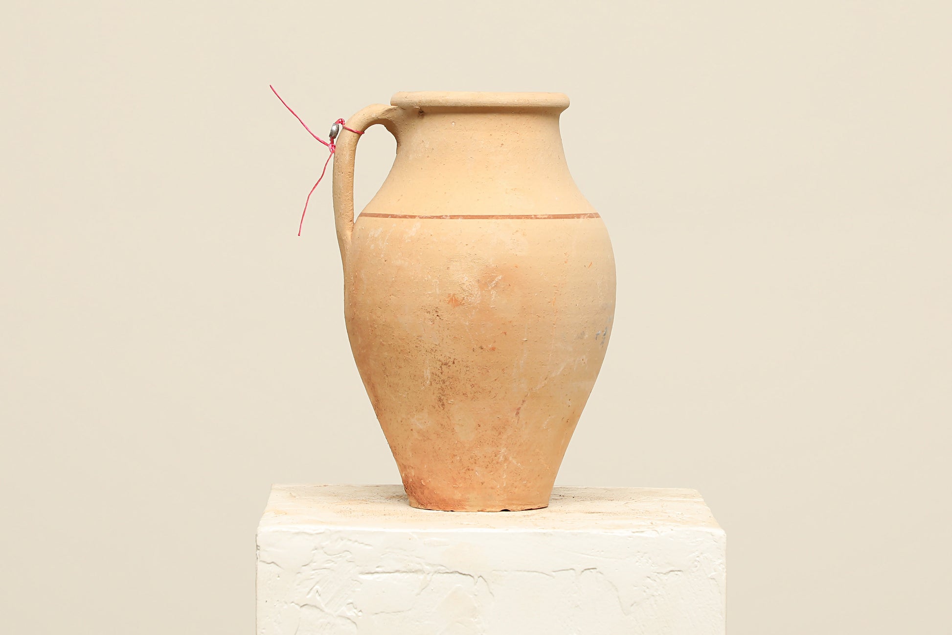 A one-of-a-kind natural Turkish vintage vase pot with a handle, crafted from terra cotta clay, this piece showcases timeless quality and antique craftsmanship, adding a unique touch of history to your space