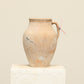 A one-of-a-kind natural Turkish vintage vase pot with a handle, crafted from terra cotta clay, this piece showcases timeless quality and antique craftsmanship, adding a unique touch of history to your space