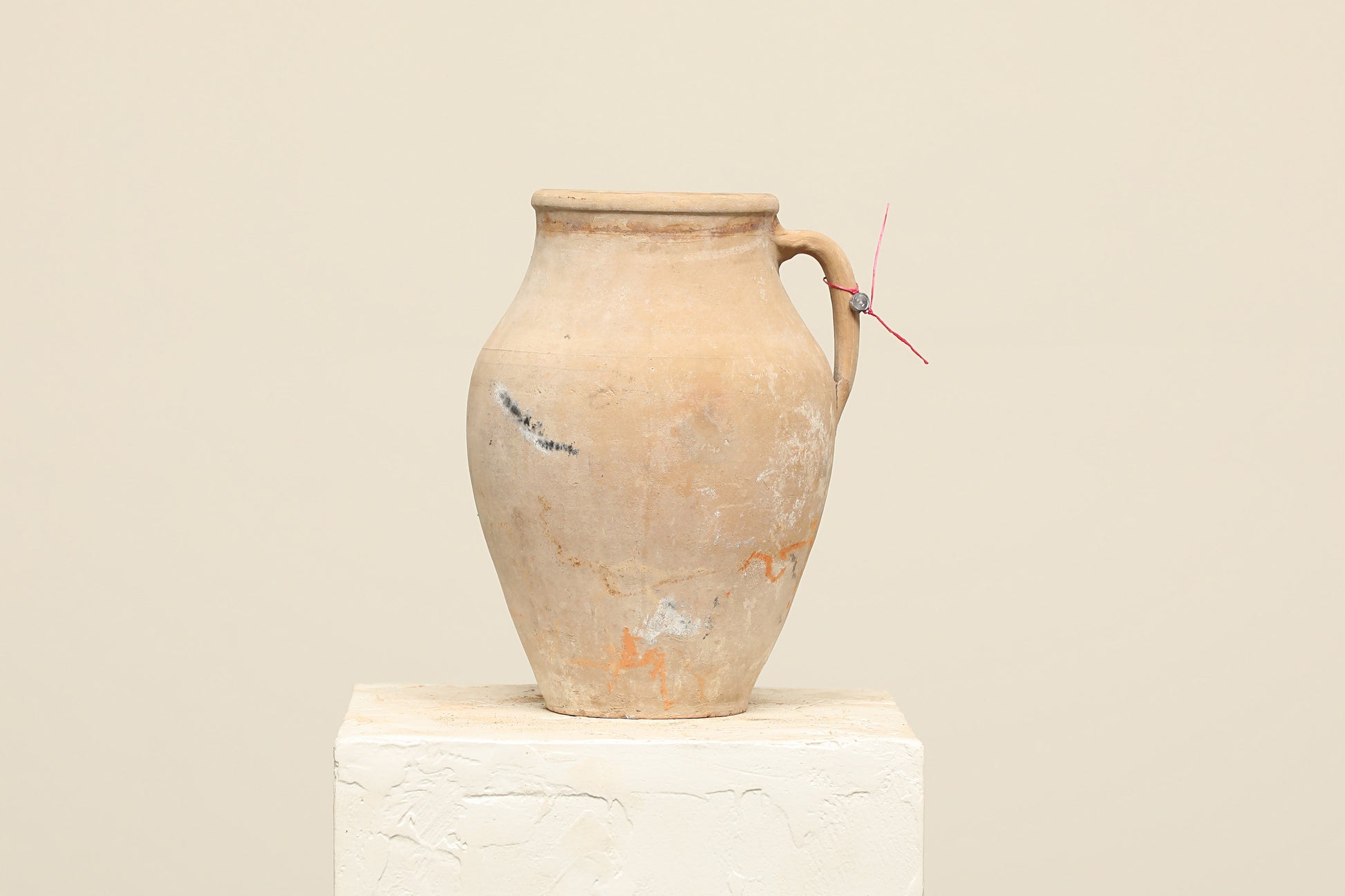 A one-of-a-kind natural Turkish vintage vase pot with a handle, crafted from terra cotta clay, this piece showcases timeless quality and antique craftsmanship, adding a unique touch of history to your space