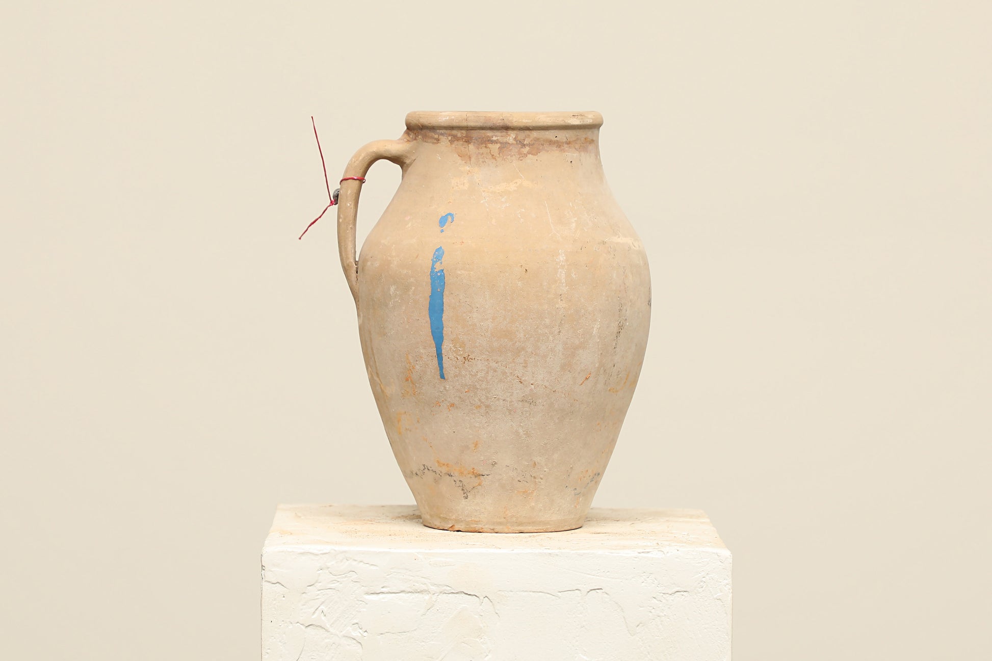 A one-of-a-kind natural Turkish vintage vase pot with a handle, crafted from terra cotta clay, this piece showcases timeless quality and antique craftsmanship, adding a unique touch of history to your space