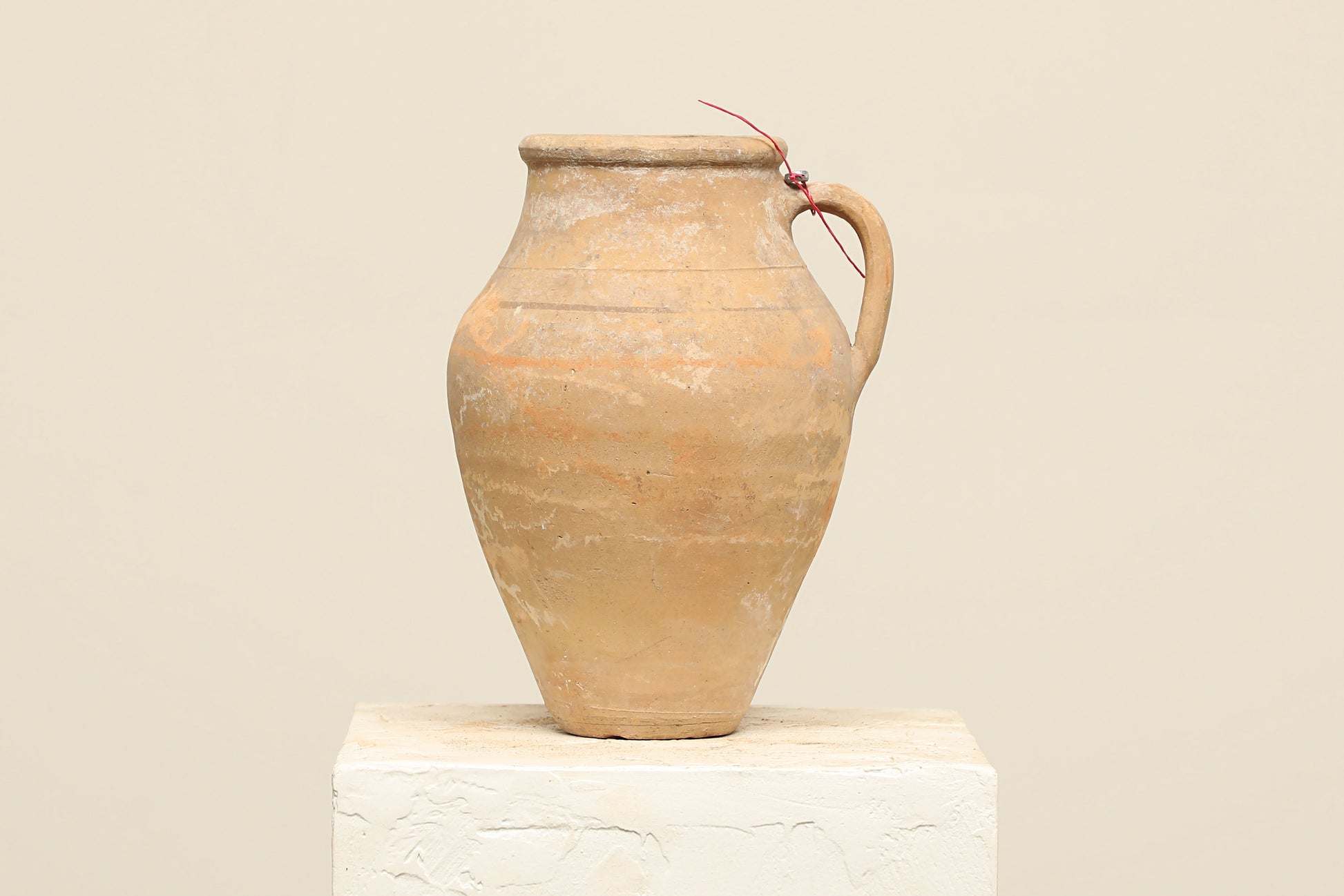 A one-of-a-kind natural Turkish vintage vase pot with a handle, crafted from terra cotta clay, this piece showcases timeless quality and antique craftsmanship, adding a unique touch of history to your space