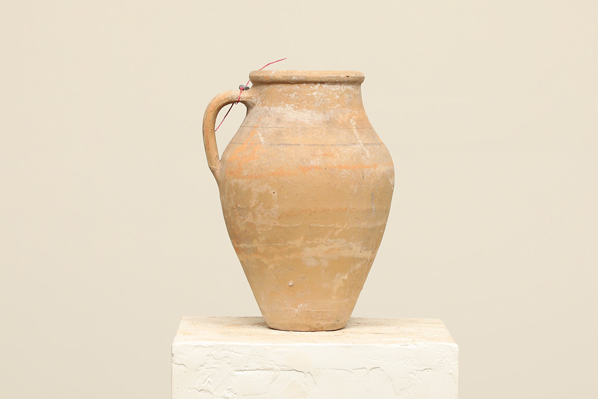 A one-of-a-kind natural Turkish vintage vase pot with a handle, crafted from terra cotta clay, this piece showcases timeless quality and antique craftsmanship, adding a unique touch of history to your space