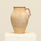 A one-of-a-kind natural Turkish vintage vase pot with a handle, crafted from terra cotta clay, this piece showcases timeless quality and antique craftsmanship, adding a unique touch of history to your space