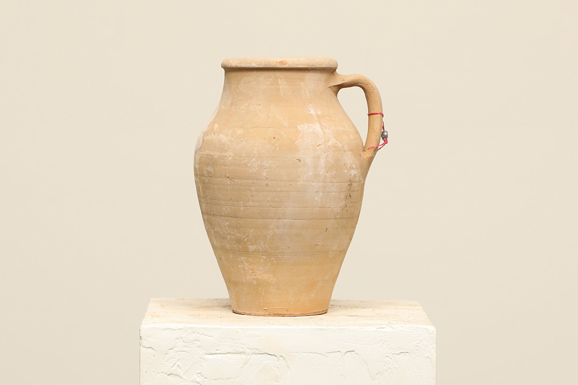 A one-of-a-kind natural Turkish vintage vase pot with a handle, crafted from terra cotta clay, this piece showcases timeless quality and antique craftsmanship, adding a unique touch of history to your space