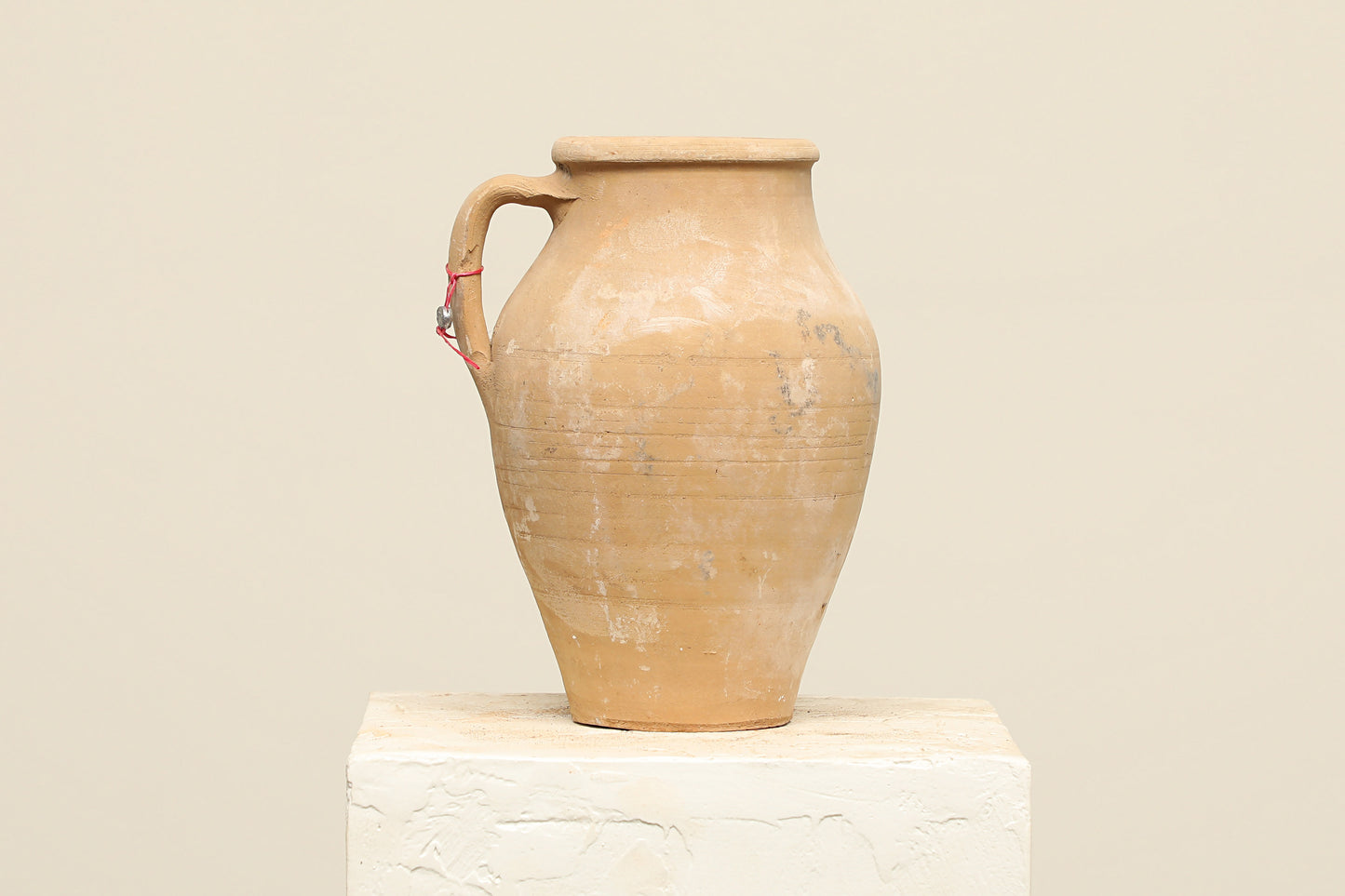 A one-of-a-kind natural Turkish vintage vase pot with a handle, crafted from terra cotta clay, this piece showcases timeless quality and antique craftsmanship, adding a unique touch of history to your space