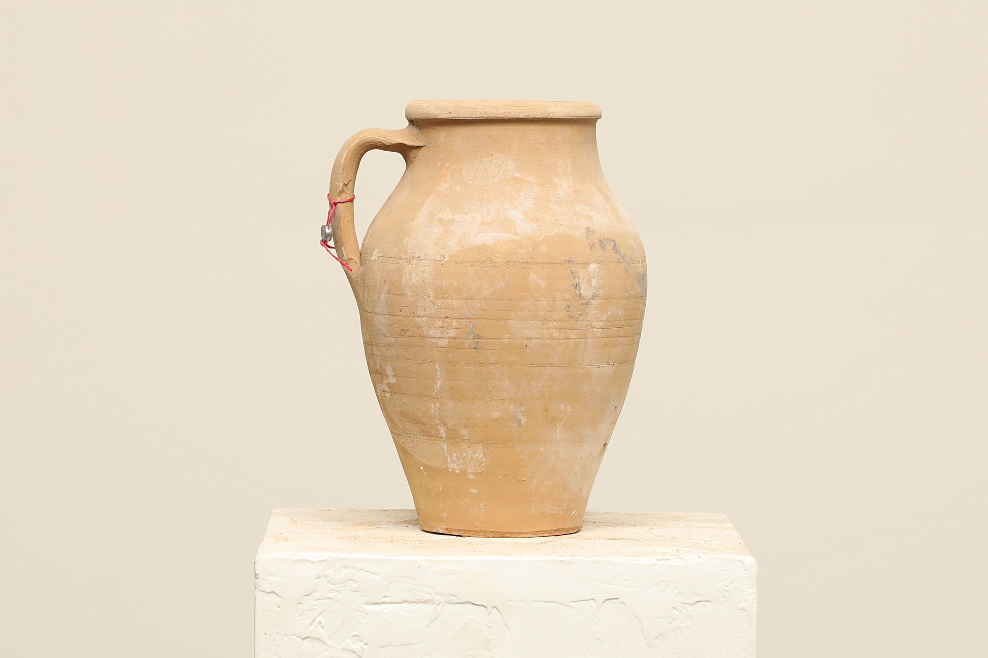 A one-of-a-kind natural Turkish vintage vase pot with a handle, crafted from terra cotta clay, this piece showcases timeless quality and antique craftsmanship, adding a unique touch of history to your space