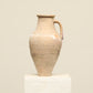 A one-of-a-kind natural Turkish vintage vase pot with a handle, crafted from terra cotta clay, this piece showcases timeless quality and antique craftsmanship, adding a unique touch of history to your space