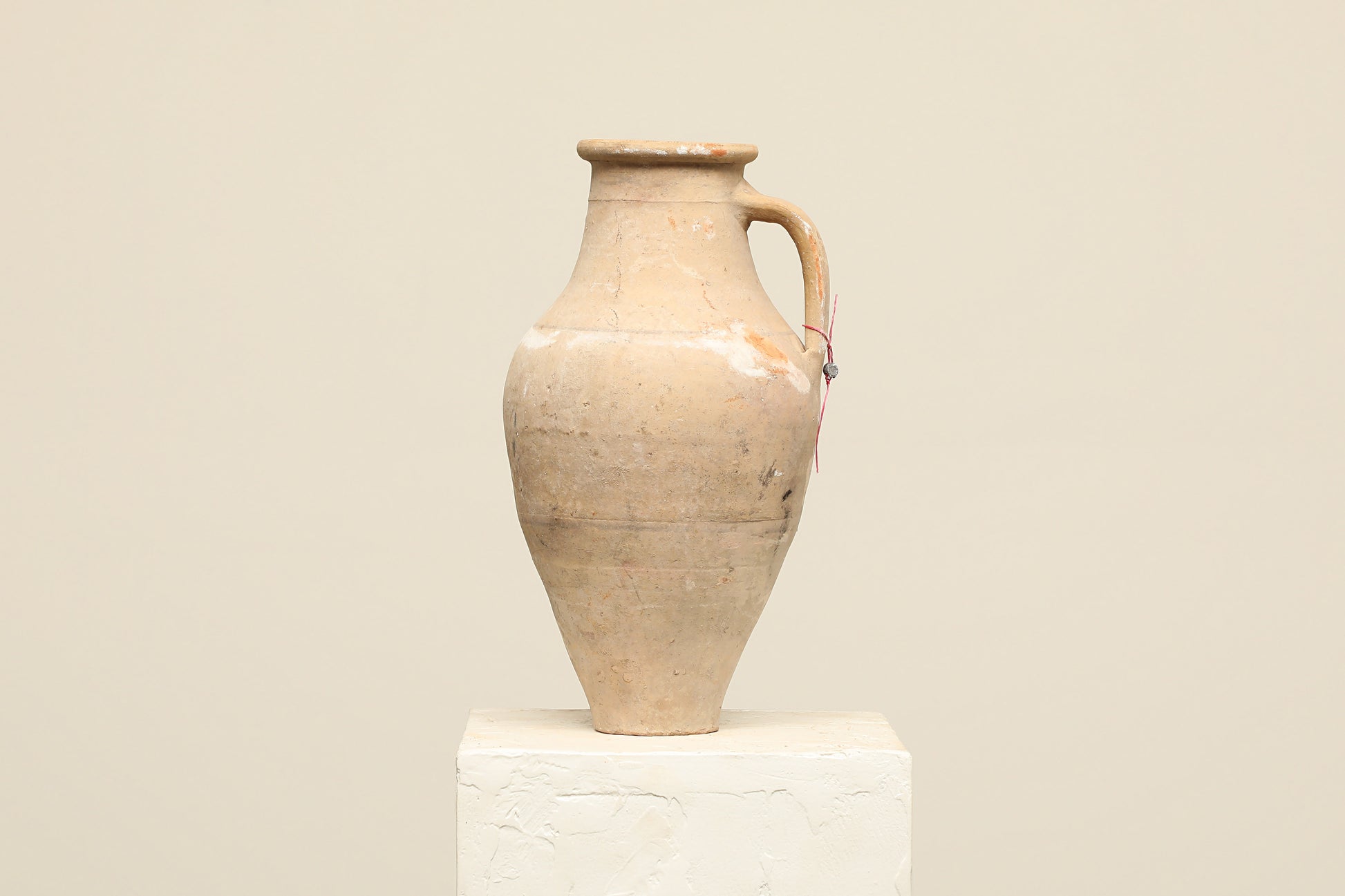 A one-of-a-kind natural Turkish vintage vase pot with a handle, crafted from terra cotta clay, this piece showcases timeless quality and antique craftsmanship, adding a unique touch of history to your space