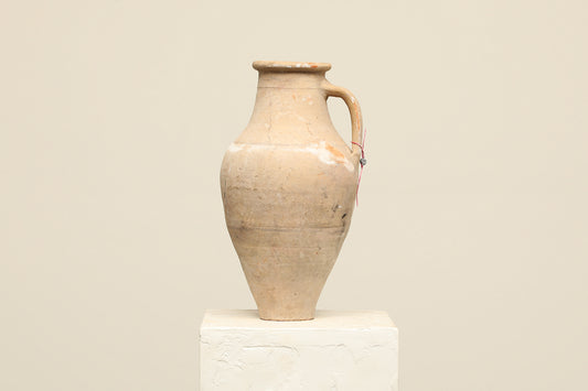 A one-of-a-kind natural Turkish vintage vase pot with a handle, crafted from terra cotta clay, this piece showcases timeless quality and antique craftsmanship, adding a unique touch of history to your space