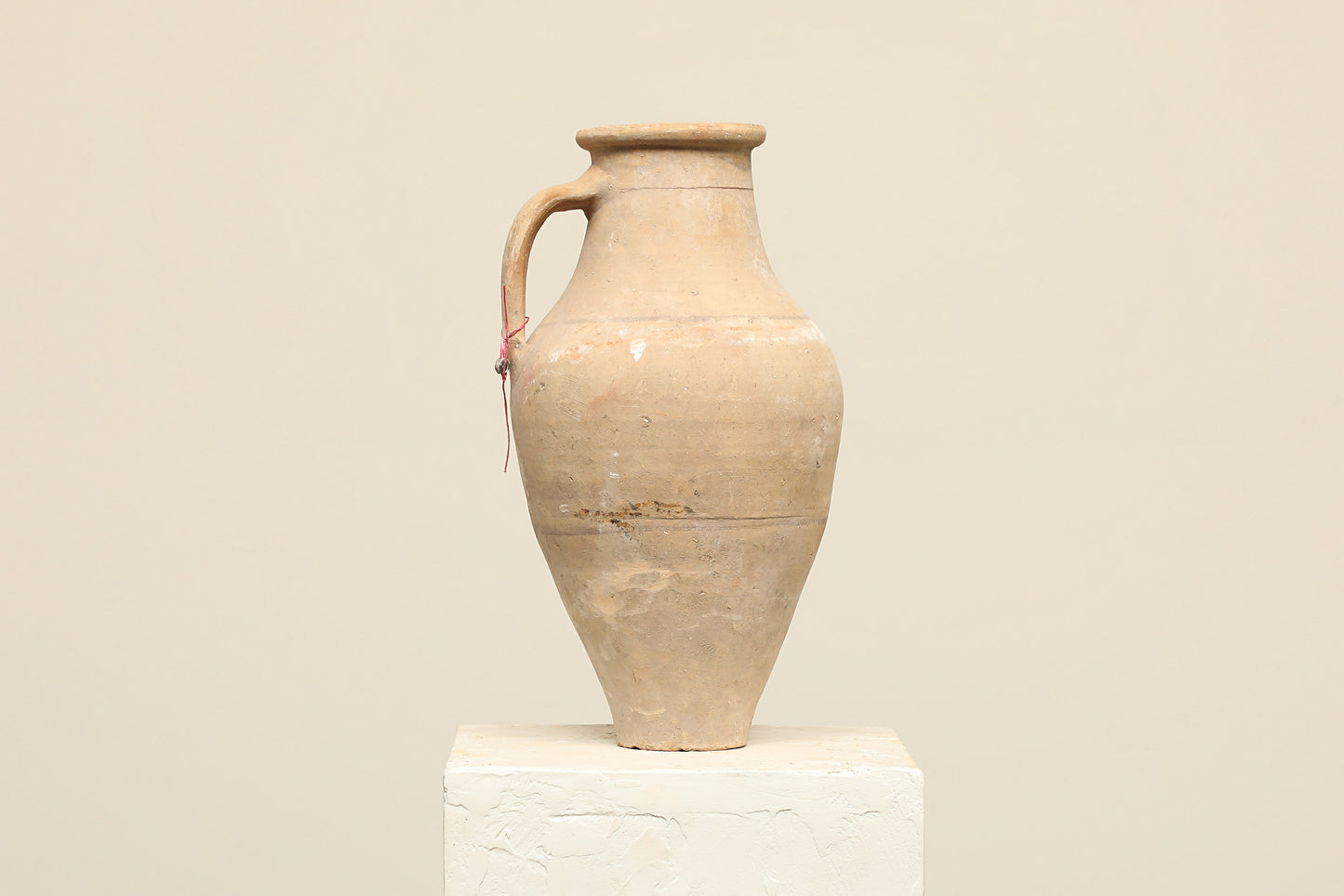 A one-of-a-kind natural Turkish vintage vase pot with a handle, crafted from terra cotta clay, this piece showcases timeless quality and antique craftsmanship, adding a unique touch of history to your space