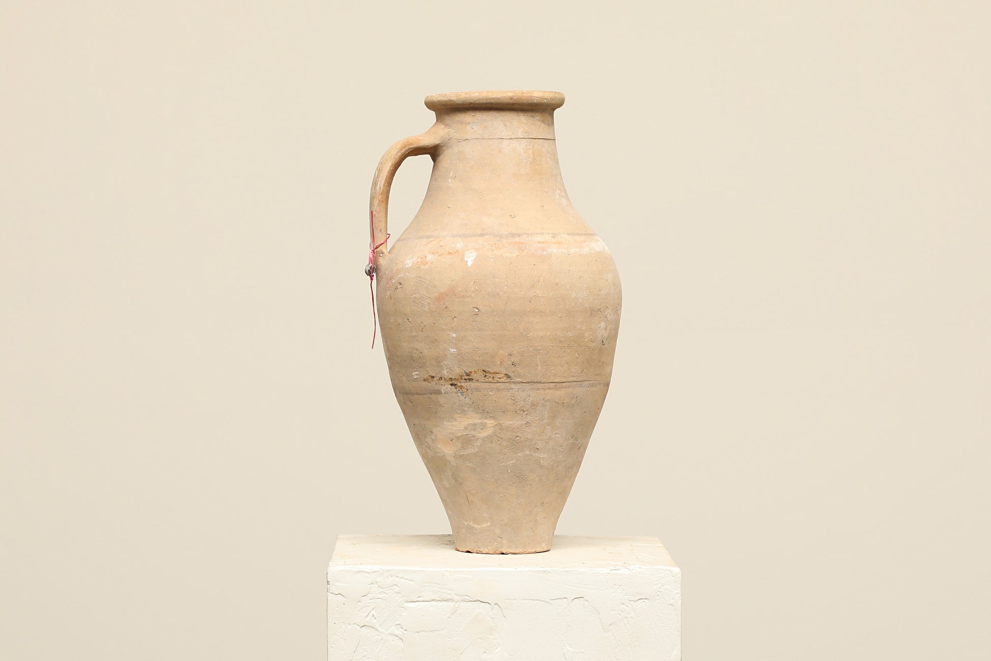 A one-of-a-kind natural Turkish vintage vase pot with a handle, crafted from terra cotta clay, this piece showcases timeless quality and antique craftsmanship, adding a unique touch of history to your space