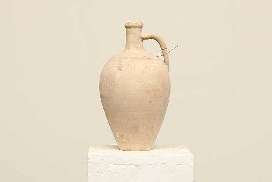 A one-of-a-kind natural Turkish vintage vase pot with a handle, crafted from terra cotta clay, this piece showcases timeless quality and antique craftsmanship, adding a unique touch of history to your space