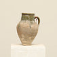 A one-of-a-kind natural Turkish vintage vase pot with a handle, crafted from terra cotta clay, this piece showcases timeless quality and antique craftsmanship, adding a unique touch of history to your space