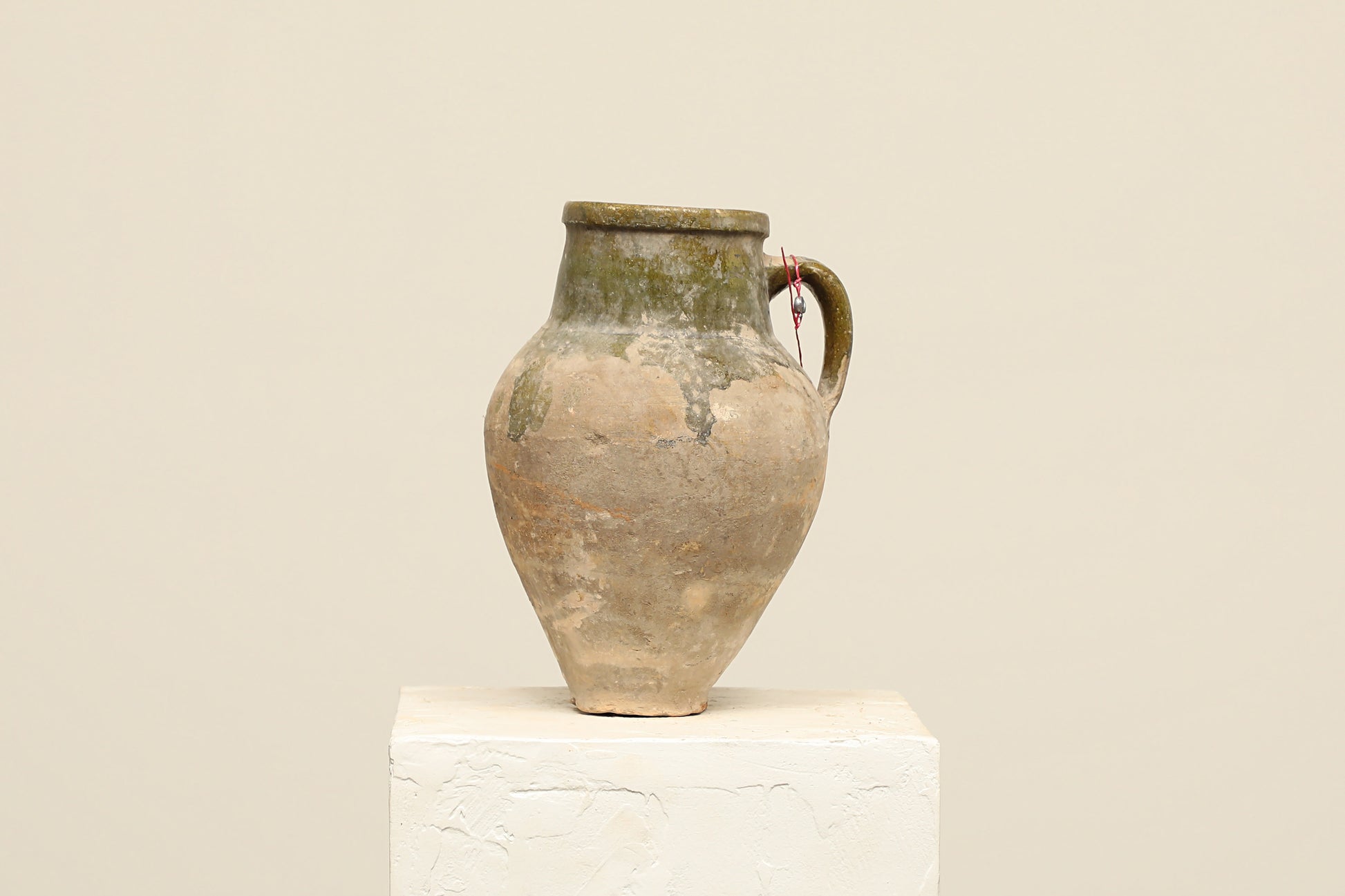 A one-of-a-kind natural Turkish vintage vase pot with a handle, crafted from terra cotta clay, this piece showcases timeless quality and antique craftsmanship, adding a unique touch of history to your space