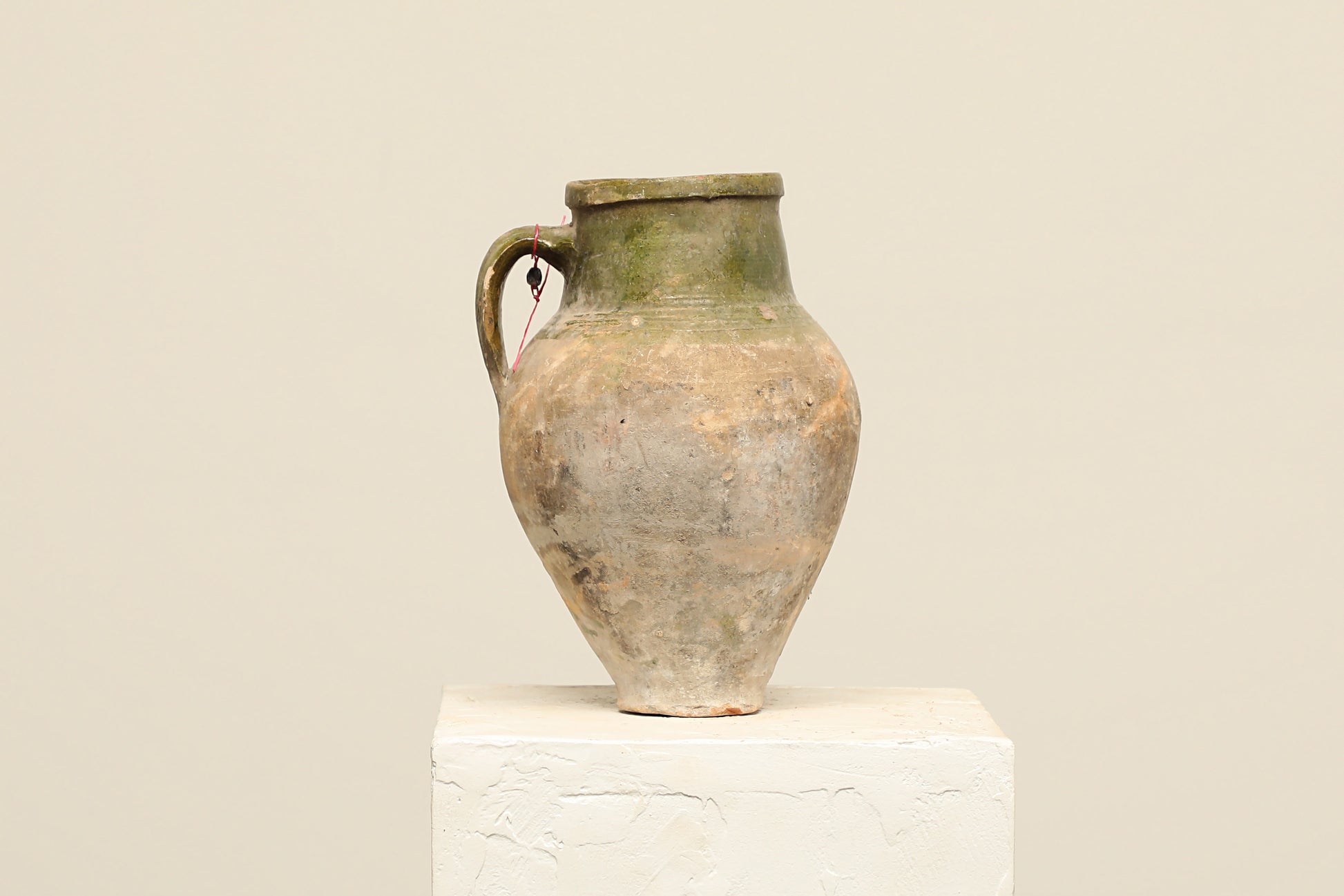 A one-of-a-kind natural Turkish vintage vase pot with a handle, crafted from terra cotta clay, this piece showcases timeless quality and antique craftsmanship, adding a unique touch of history to your space