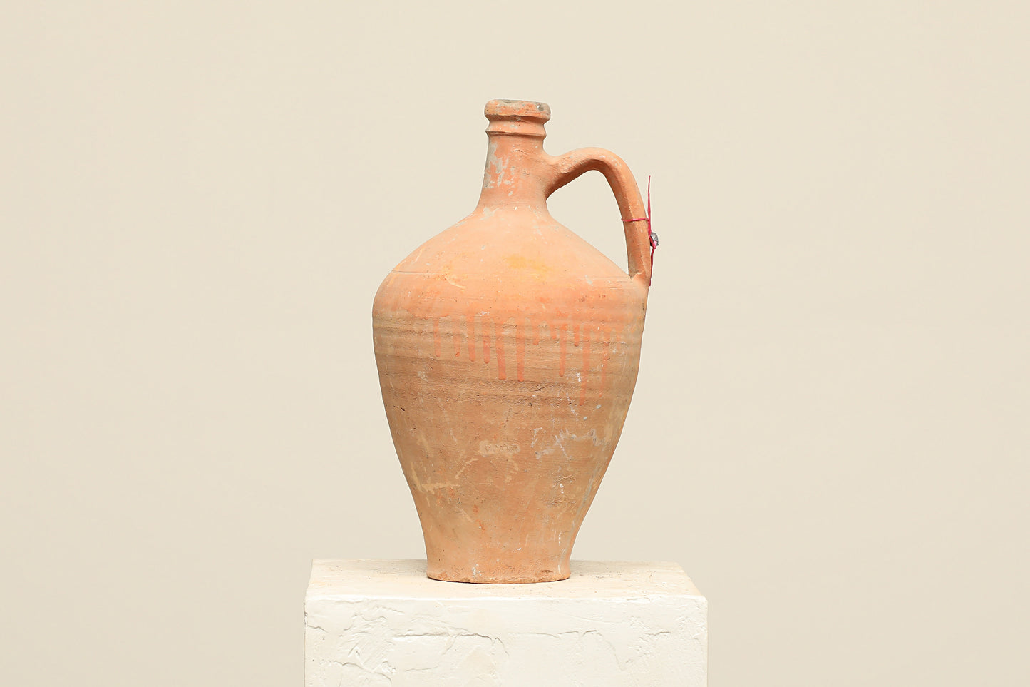 A one-of-a-kind natural Turkish vintage vase pot with a handle, crafted from terra cotta clay, this piece showcases timeless quality and antique craftsmanship, adding a unique touch of history to your space