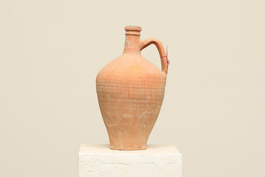 A one-of-a-kind natural Turkish vintage vase pot with a handle, crafted from terra cotta clay, this piece showcases timeless quality and antique craftsmanship, adding a unique touch of history to your space
