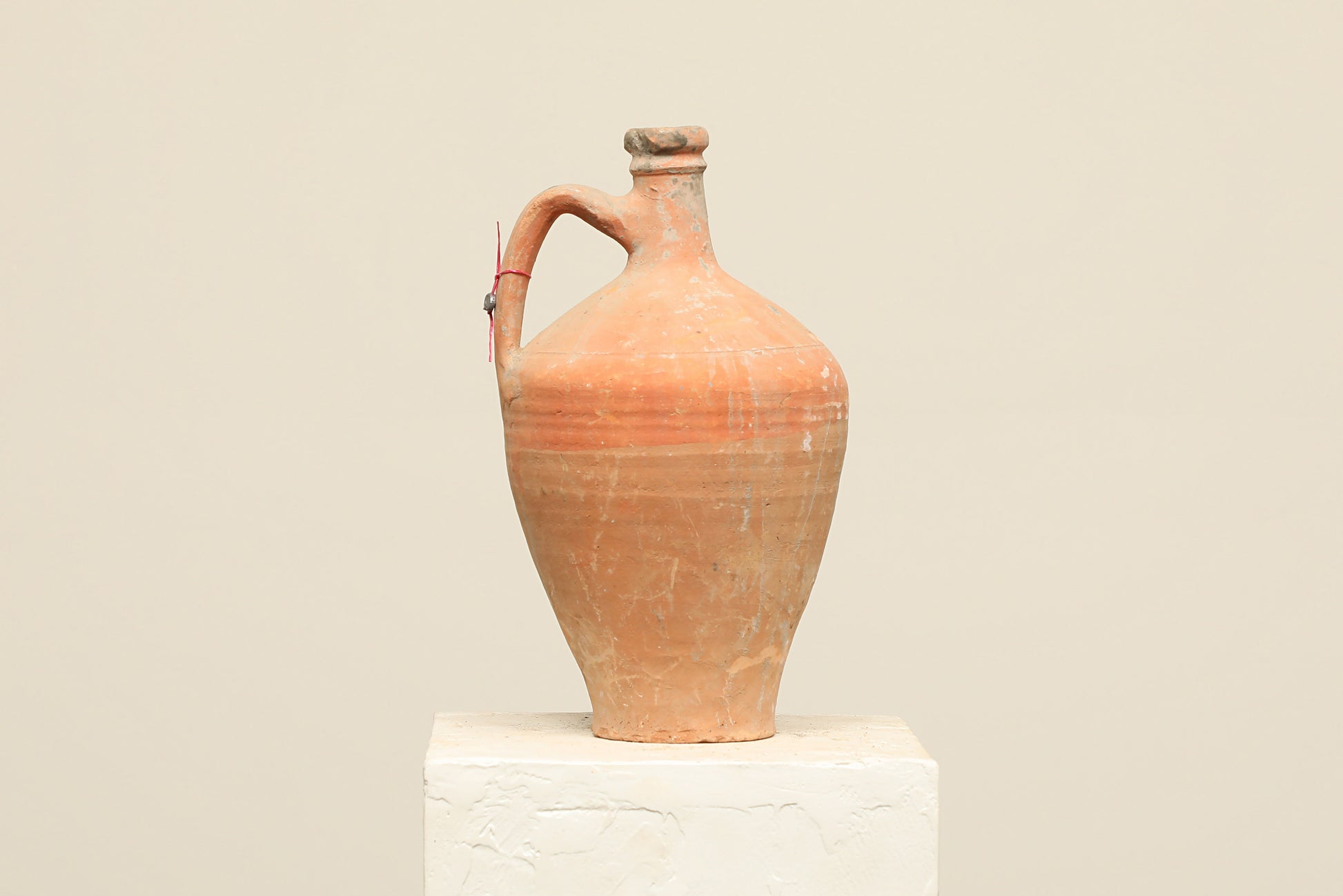 A one-of-a-kind natural Turkish vintage vase pot with a handle, crafted from terra cotta clay, this piece showcases timeless quality and antique craftsmanship, adding a unique touch of history to your space