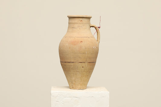 A one-of-a-kind natural Turkish vintage vase pot with a handle, crafted from terra cotta clay, this piece showcases timeless quality and antique craftsmanship, adding a unique touch of history to your space