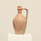 A one-of-a-kind natural Turkish vintage vase pot with a handle, crafted from terra cotta clay, this piece showcases timeless quality and antique craftsmanship, adding a unique touch of history to your space