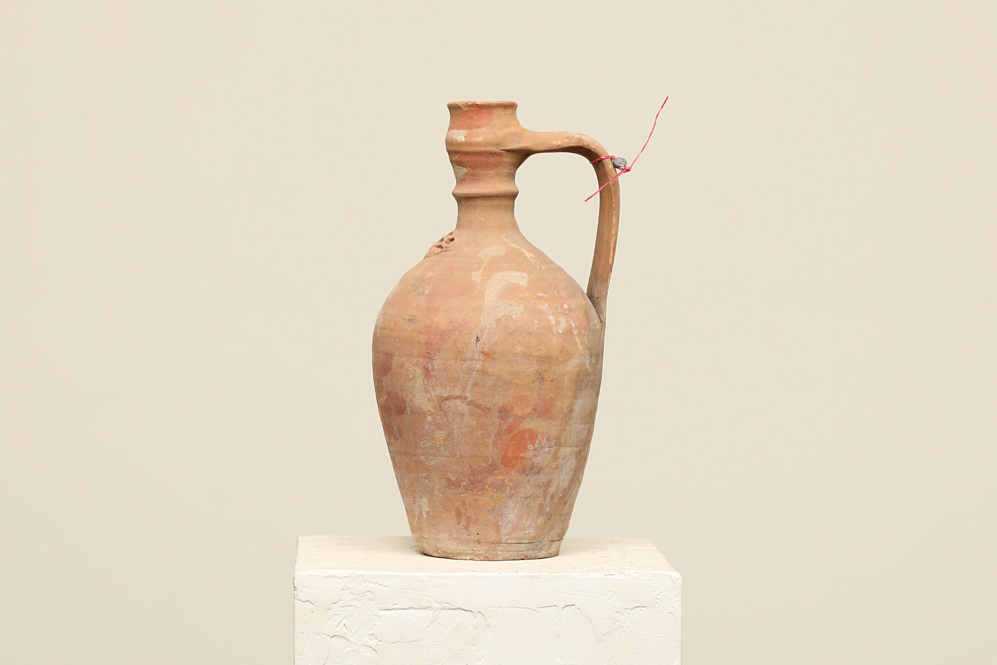 A one-of-a-kind natural Turkish vintage vase pot with a handle, crafted from terra cotta clay, this piece showcases timeless quality and antique craftsmanship, adding a unique touch of history to your space