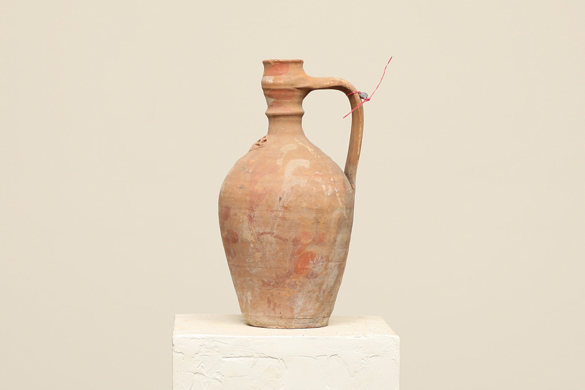 A one-of-a-kind natural Turkish vintage vase pot with a handle, crafted from terra cotta clay, this piece showcases timeless quality and antique craftsmanship, adding a unique touch of history to your space