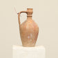 A one-of-a-kind natural Turkish vintage vase pot with a handle, crafted from terra cotta clay, this piece showcases timeless quality and antique craftsmanship, adding a unique touch of history to your space