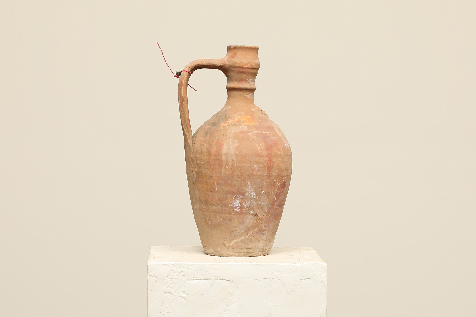 A one-of-a-kind natural Turkish vintage vase pot with a handle, crafted from terra cotta clay, this piece showcases timeless quality and antique craftsmanship, adding a unique touch of history to your space
