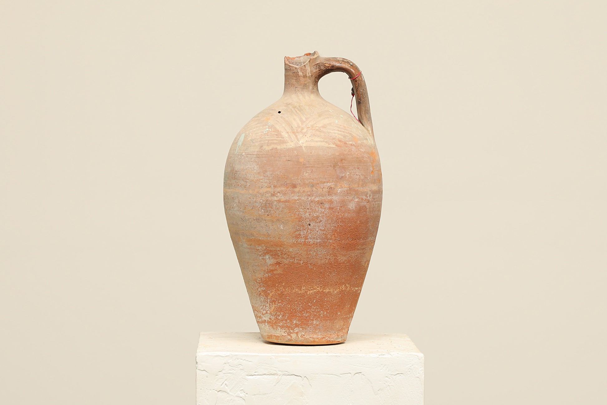 A one-of-a-kind natural Turkish vintage vase pot with a handle, crafted from terra cotta clay, this piece showcases timeless quality and antique craftsmanship, adding a unique touch of history to your space