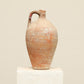 A one-of-a-kind natural Turkish vintage vase pot with a handle, crafted from terra cotta clay, this piece showcases timeless quality and antique craftsmanship, adding a unique touch of history to your space