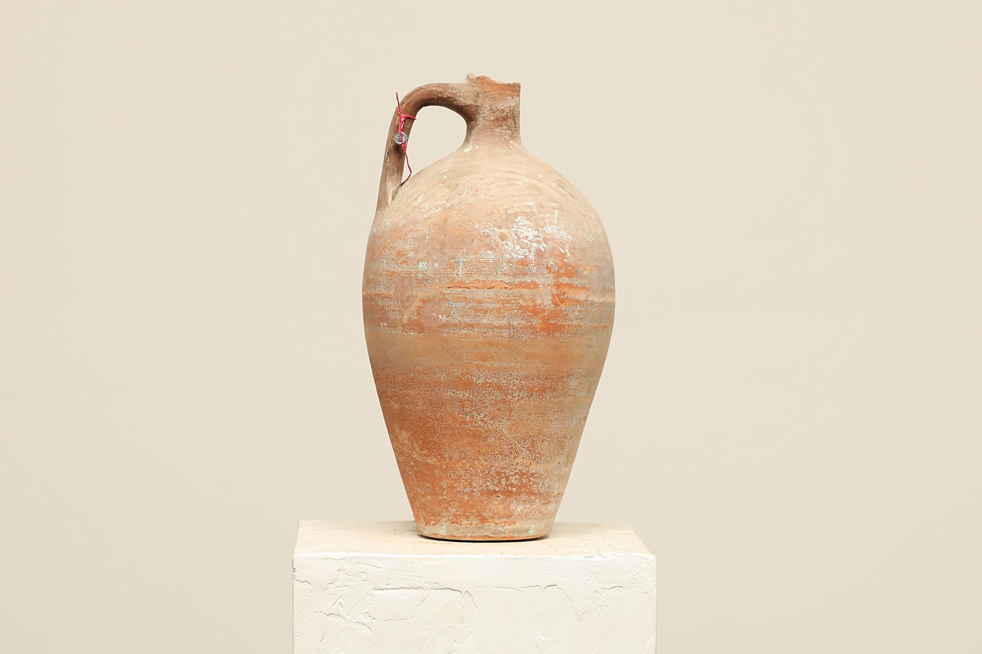 A one-of-a-kind natural Turkish vintage vase pot with a handle, crafted from terra cotta clay, this piece showcases timeless quality and antique craftsmanship, adding a unique touch of history to your space