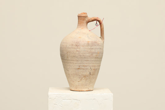A one-of-a-kind natural Turkish vintage vase pot with a handle, crafted from terra cotta clay, this piece showcases timeless quality and antique craftsmanship, adding a unique touch of history to your space