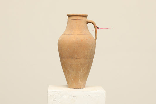 A one-of-a-kind natural Turkish vintage vase pot with a handle, crafted from terra cotta clay, this piece showcases timeless quality and antique craftsmanship, adding a unique touch of history to your space
