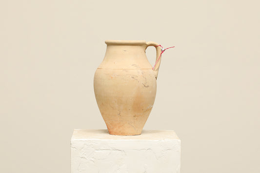A one-of-a-kind neutral Turkish vintage vase pot with a handle, crafted from terra cotta clay, this piece showcases timeless quality and antique craftsmanship, adding a unique touch of history to your space