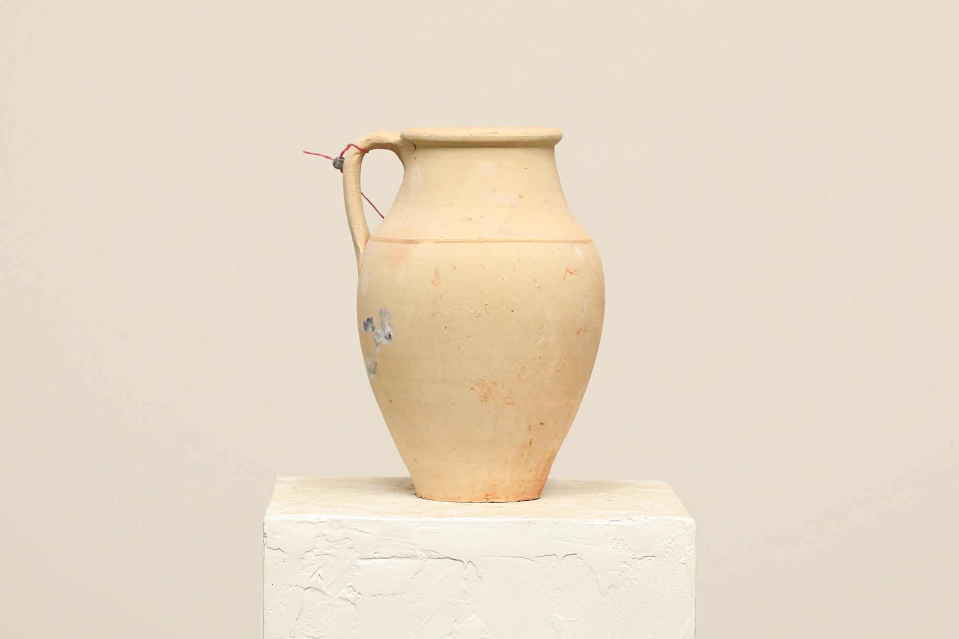 A one-of-a-kind neutral Turkish vintage vase pot with a handle, crafted from terra cotta clay, this piece showcases timeless quality and antique craftsmanship, adding a unique touch of history to your space