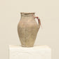 A one-of-a-kind neutral Turkish vintage vase pot with a handle, crafted from terra cotta clay, this piece showcases timeless quality and antique craftsmanship, adding a unique touch of history to your space