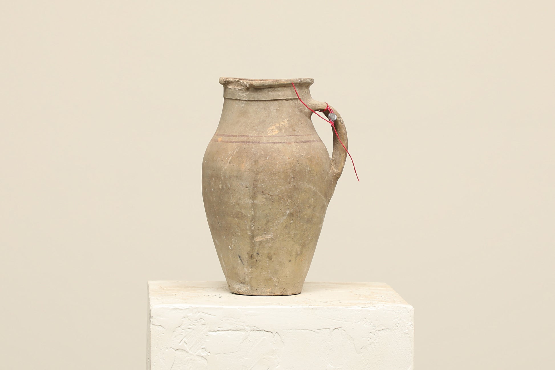 A one-of-a-kind neutral Turkish vintage vase pot with a handle, crafted from terra cotta clay, this piece showcases timeless quality and antique craftsmanship, adding a unique touch of history to your space