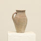 A one-of-a-kind neutral Turkish vintage vase pot with a handle, crafted from terra cotta clay, this piece showcases timeless quality and antique craftsmanship, adding a unique touch of history to your space