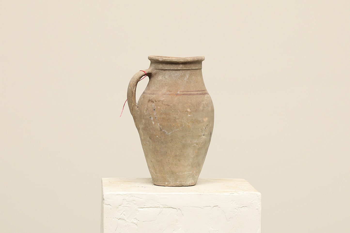 A one-of-a-kind neutral Turkish vintage vase pot with a handle, crafted from terra cotta clay, this piece showcases timeless quality and antique craftsmanship, adding a unique touch of history to your space