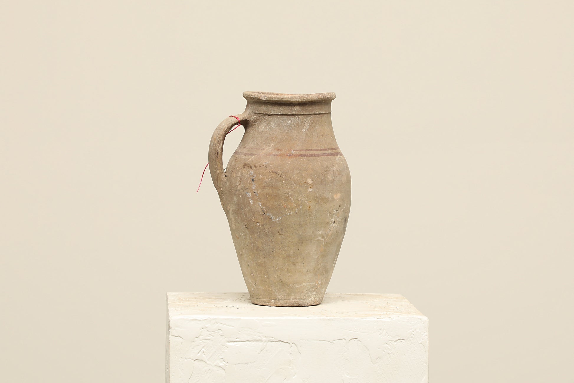 A one-of-a-kind neutral Turkish vintage vase pot with a handle, crafted from terra cotta clay, this piece showcases timeless quality and antique craftsmanship, adding a unique touch of history to your space