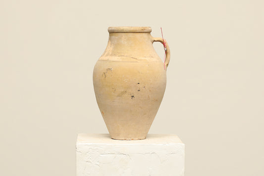 A one-of-a-kind neutral Turkish vintage vase pot with a handle, crafted from terra cotta clay, this piece showcases timeless quality and antique craftsmanship, adding a unique touch of history to your space