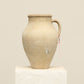 A one-of-a-kind neutral Turkish vintage vase pot with a handle, crafted from terra cotta clay, this piece showcases timeless quality and antique craftsmanship, adding a unique touch of history to your space