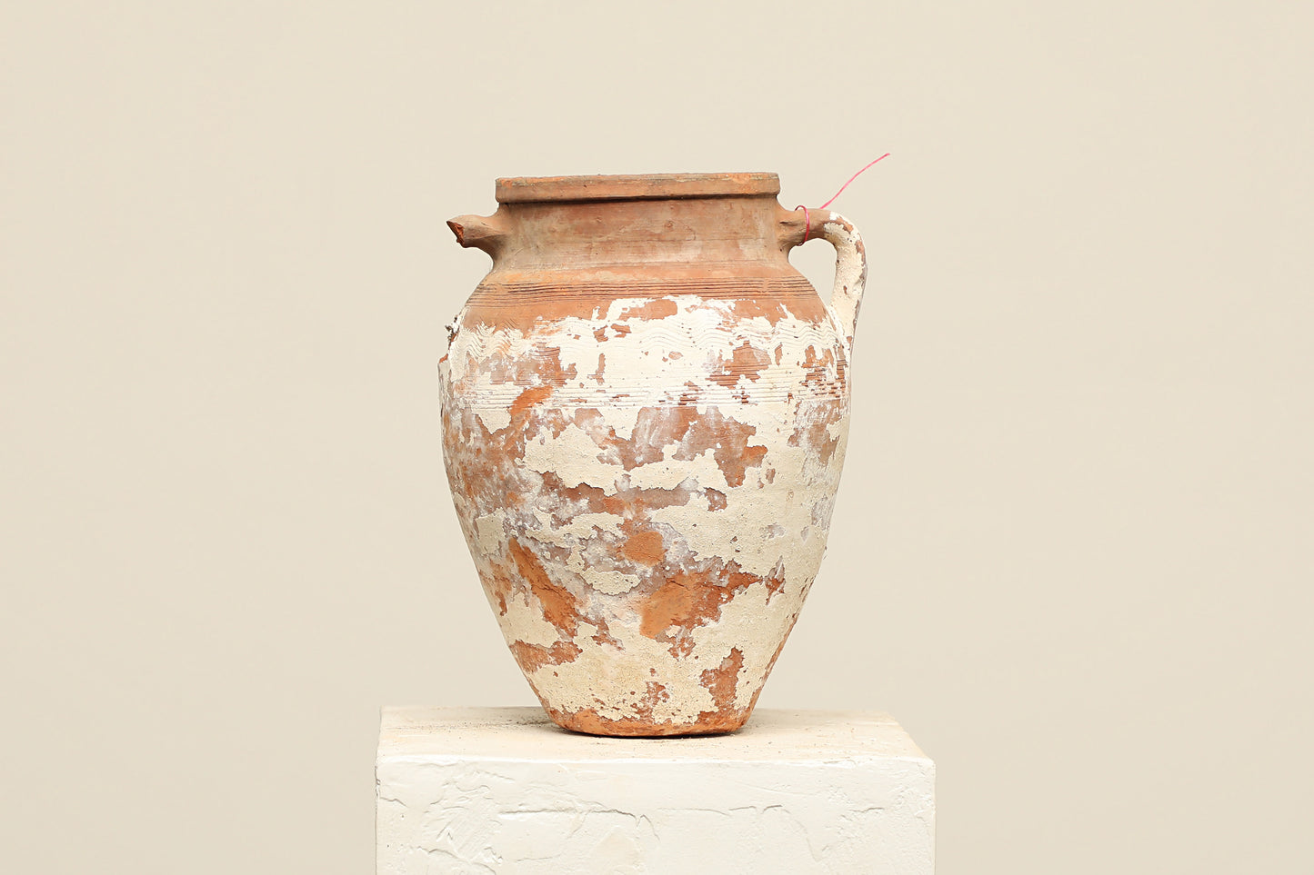 A one-of-a-kind neutral Turkish vintage vase pot with a handle, crafted from terra cotta clay, this piece showcases timeless quality and antique craftsmanship, adding a unique touch of history to your space