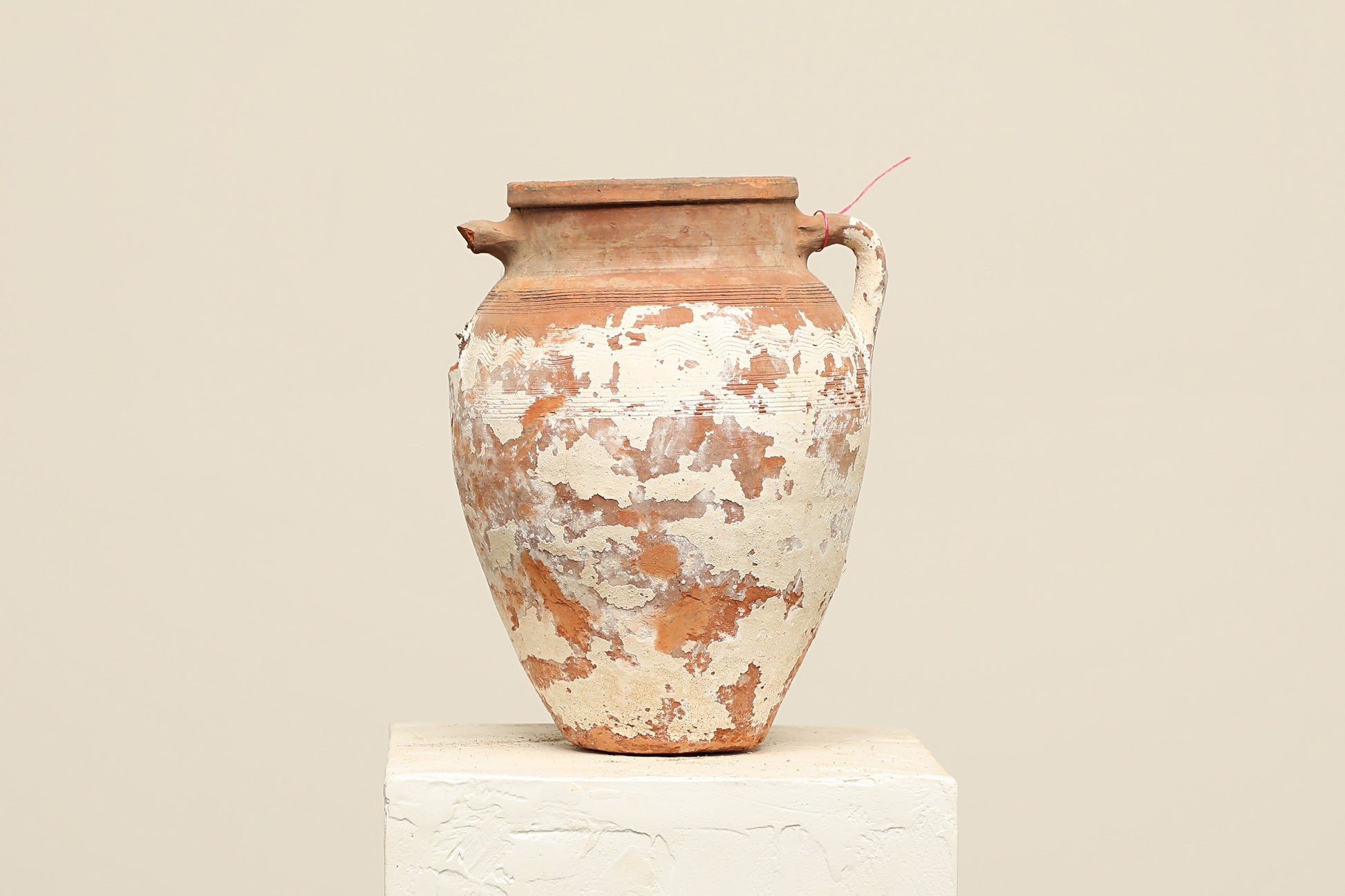 A one-of-a-kind neutral Turkish vintage vase pot with a handle, crafted from terra cotta clay, this piece showcases timeless quality and antique craftsmanship, adding a unique touch of history to your space