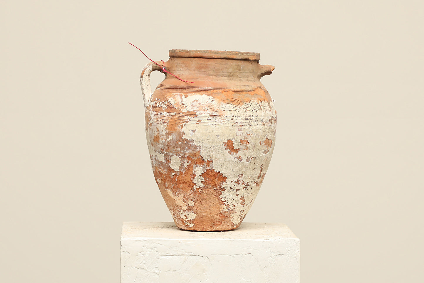 A one-of-a-kind neutral Turkish vintage vase pot with a handle, crafted from terra cotta clay, this piece showcases timeless quality and antique craftsmanship, adding a unique touch of history to your space