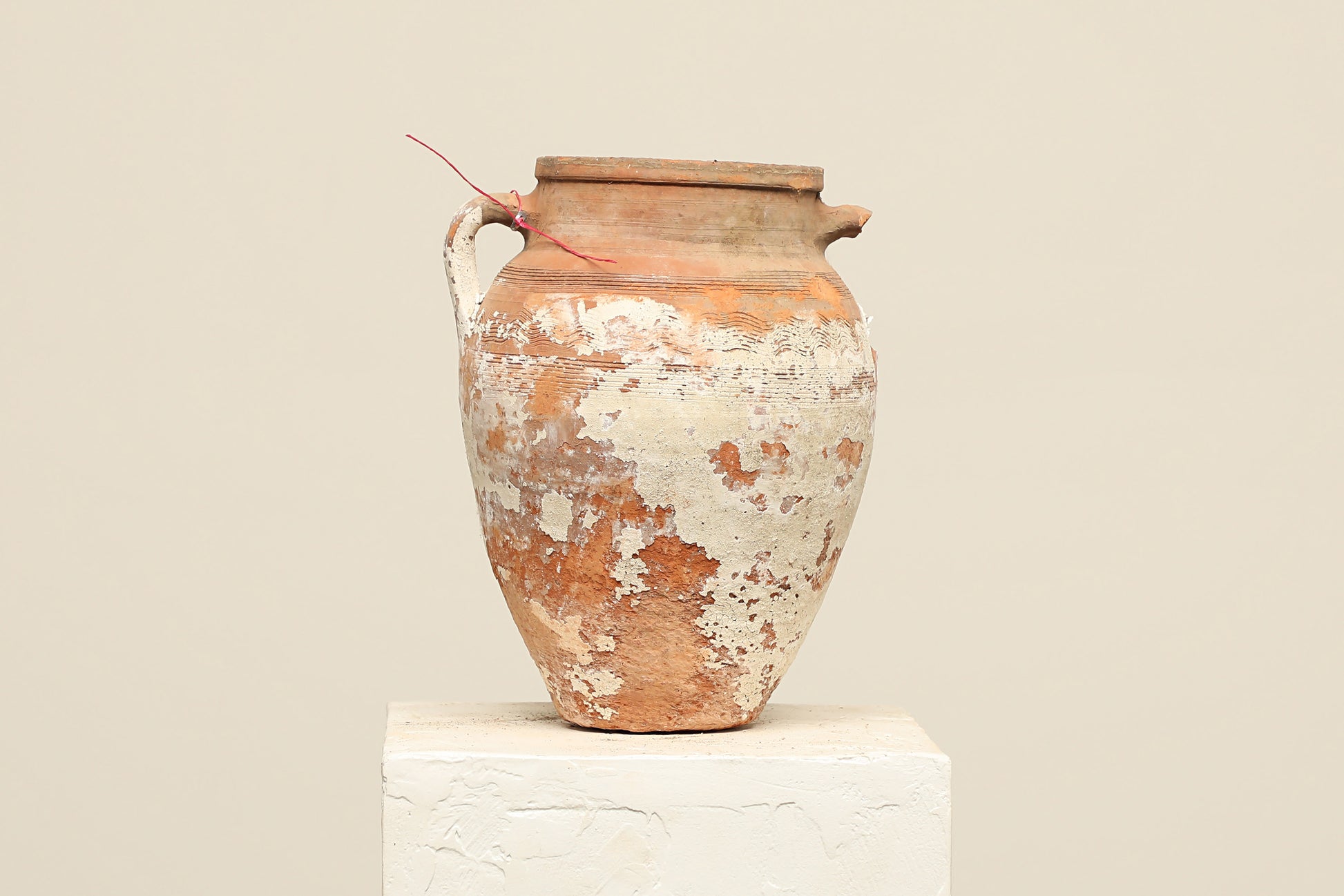 A one-of-a-kind neutral Turkish vintage vase pot with a handle, crafted from terra cotta clay, this piece showcases timeless quality and antique craftsmanship, adding a unique touch of history to your space