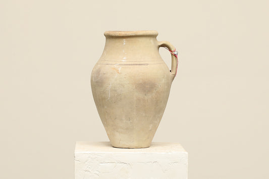 A one-of-a-kind neutral Turkish vintage vase pot with a handle, crafted from terra cotta clay, this piece showcases timeless quality and antique craftsmanship, adding a unique touch of history to your space