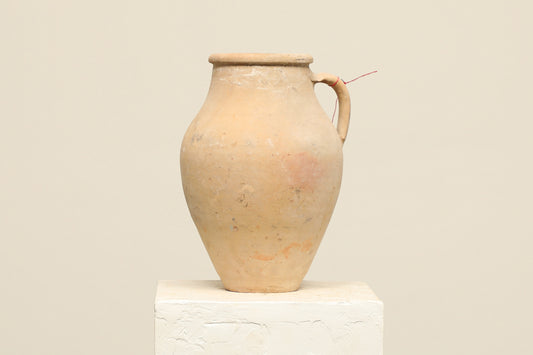 A one-of-a-kind neutral Turkish vintage vase pot with a handle, crafted from terra cotta clay, this piece showcases timeless quality and antique craftsmanship, adding a unique touch of history to your space